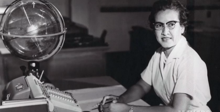 Katherine Johnson at her desk at NASA with a celestial training globe
